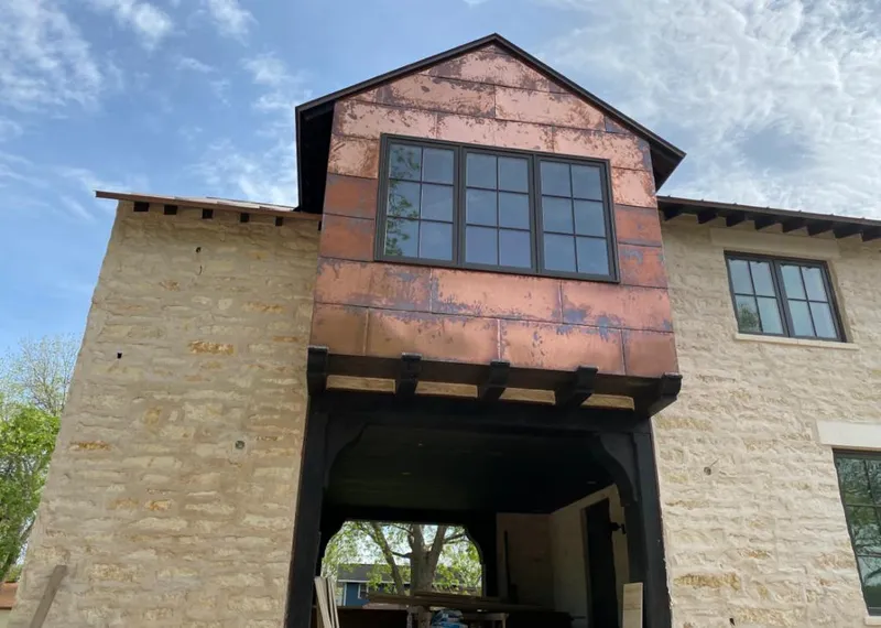 Copper metal panel facade on a stone building for Skylight Installation in Southwick